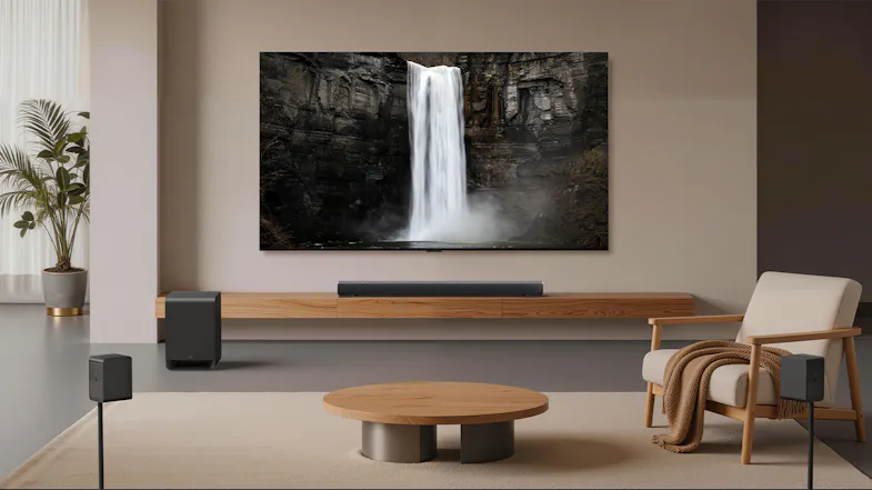 Front view of a TCL home theatre setup with a wall-mounted TV, soundbar, wireless speakers, and subwoofer Front view of a TCL home theatre setup with a wall-mounted TV, soundbar, wireless speakers, and subwoofer