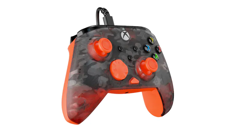 Xbox-compatible wired gaming controller featuring a dark grey and orange camouflage-patterned shell with bright orange thumbsticks and a matching directional pad Xbox-compatible wired gaming controller featuring a dark grey and orange camouflage-patterned shell with bright orange thumbsticks and a matching directional pad