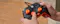 Hands holding a Turtle Beach Rematch wired Xbox controller featuring a black camouflage pattern and bright orange thumbsticks Hands holding a Turtle Beach Rematch wired Xbox controller featuring a black camouflage pattern and bright orange thumbsticks