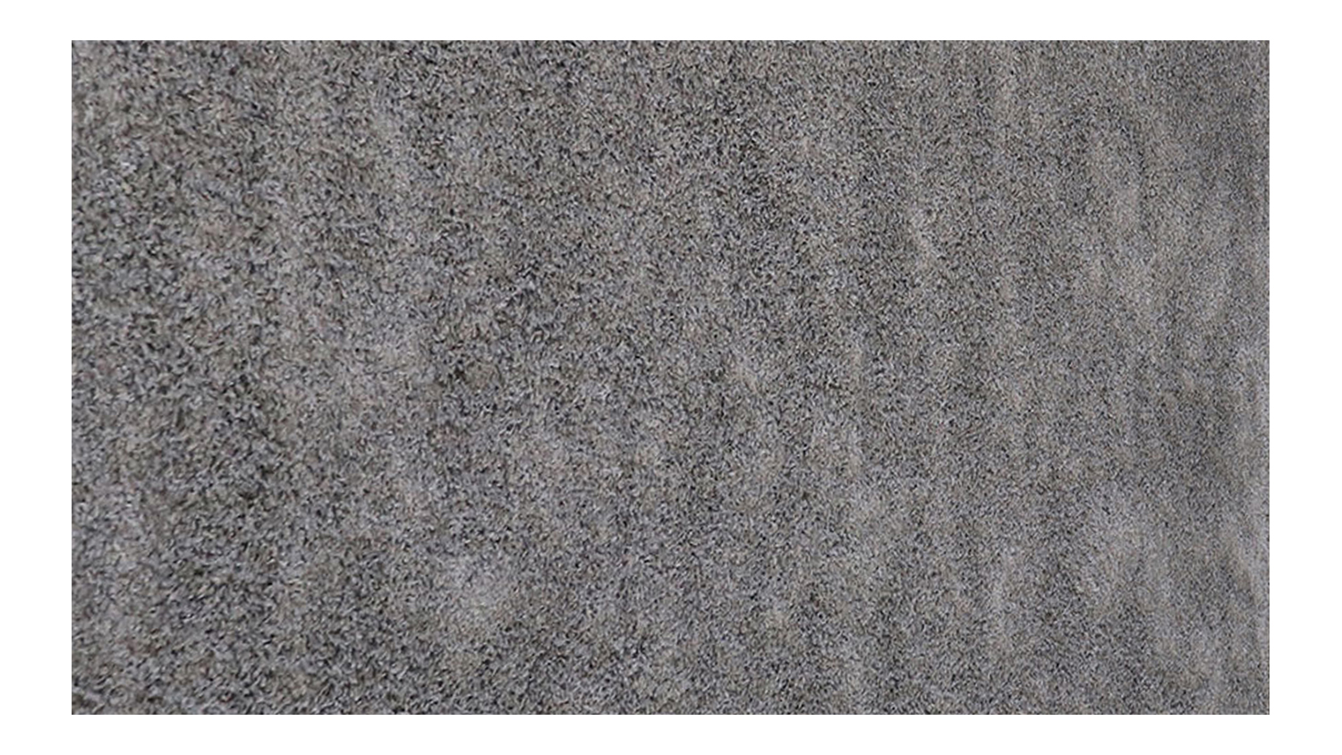 A rectangular rug in soft pebble grey with a plush, uniform texture.