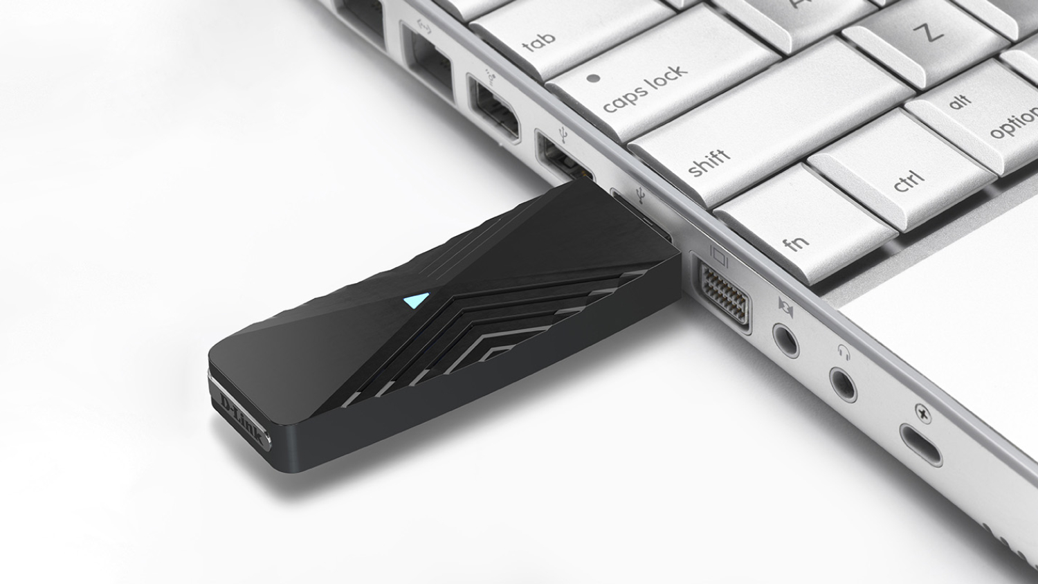 D-Link AX1800 adapter is plugged into the USB port of a silver laptop.