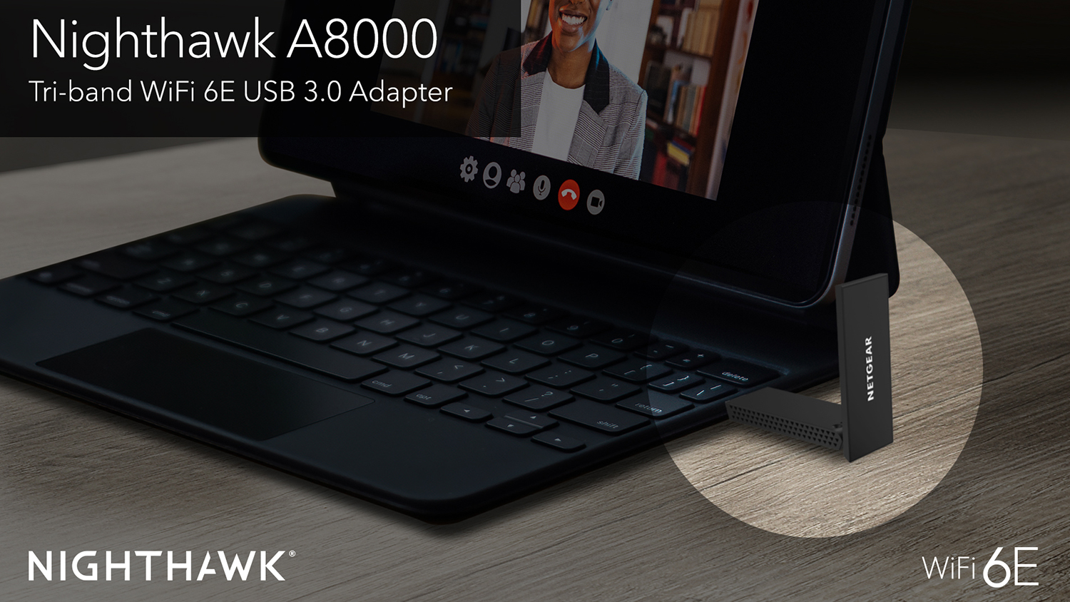 A Nighthawk A8000 Tri-band adapter plugged into a laptop on a video call.