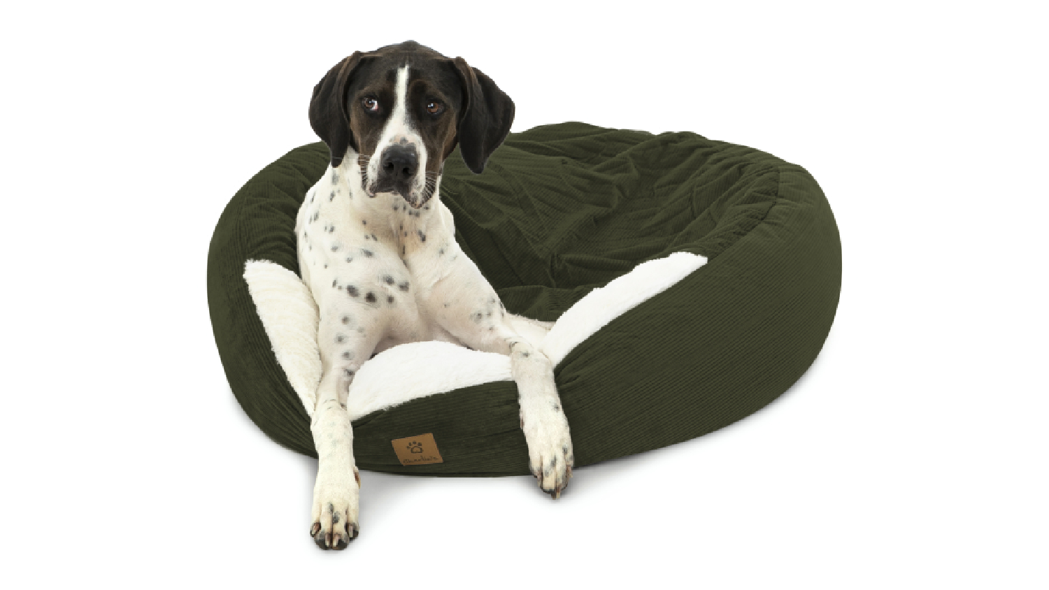 A dog resting on the corduroy pet bed.