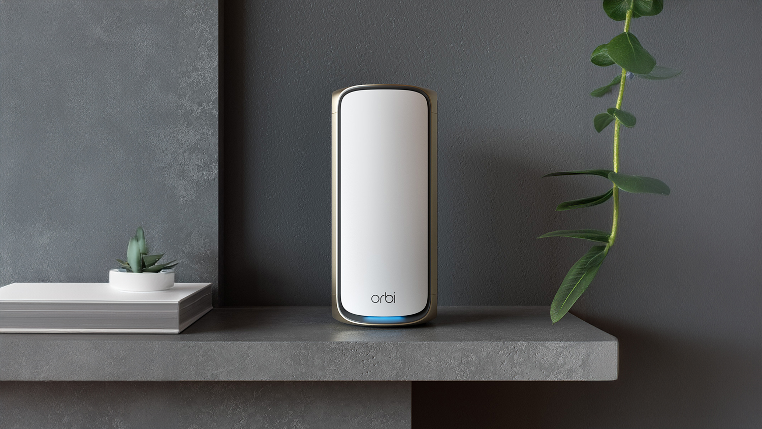 A sleek, modern Netgear Orbi RBE970 BE27000 Quad-Band Mesh Wi-Fi 7 sits centred on a dark grey stone shelf.