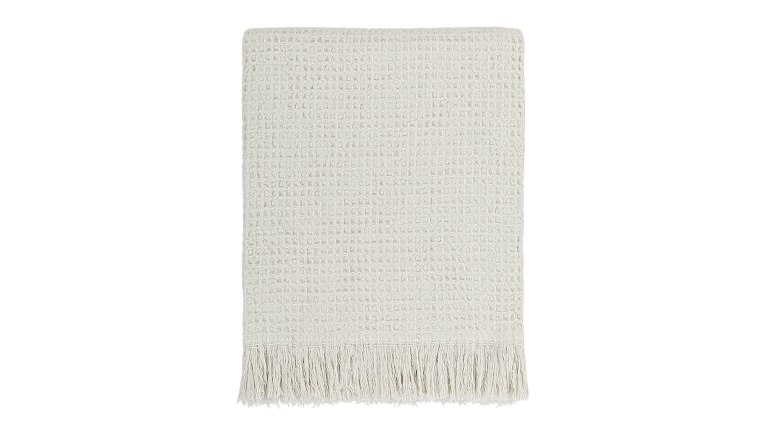 A Celine ecru-coloured waffle weave throw blanket neatly folded, featuring fringed edges