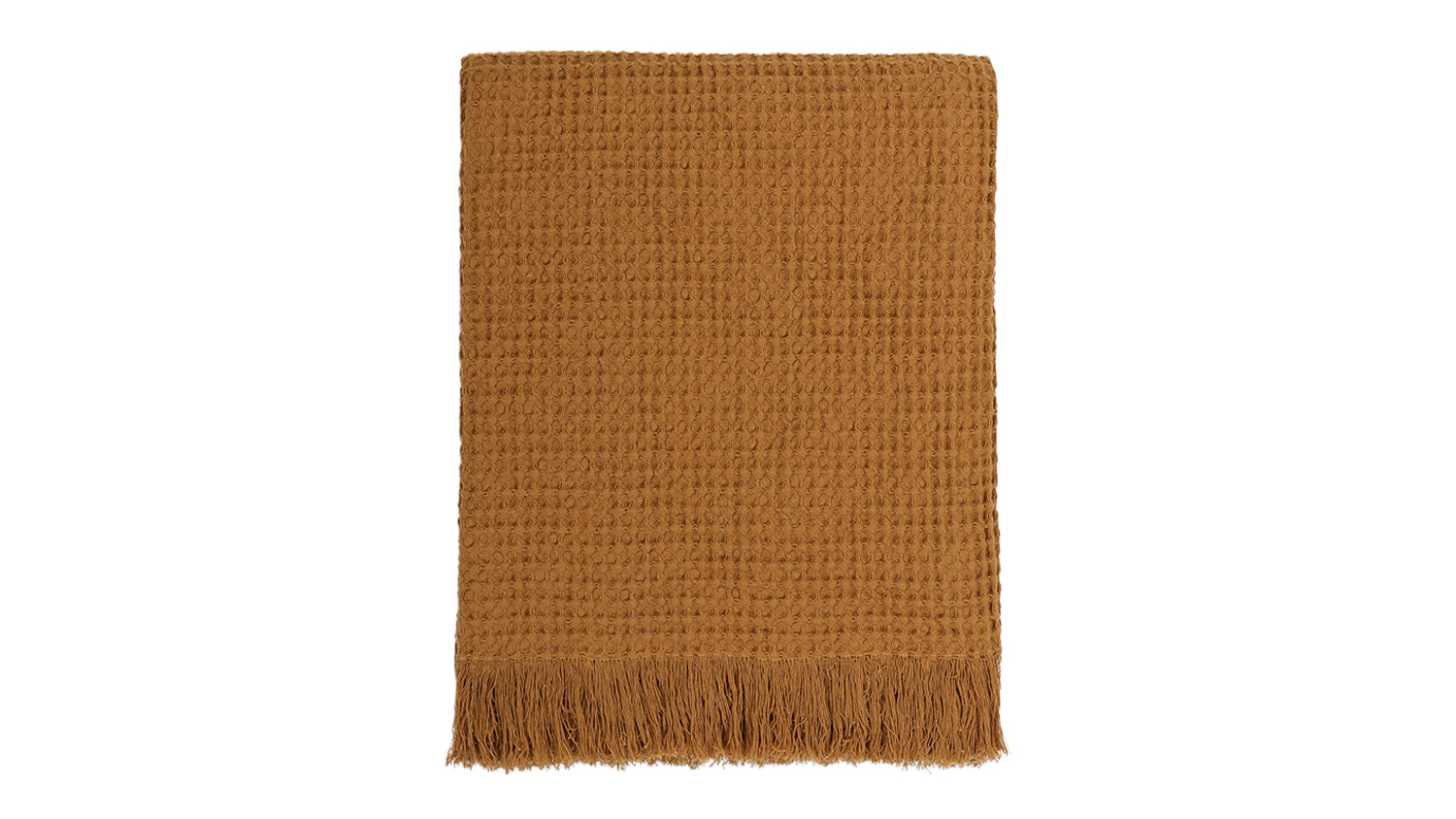 A Celine toffee-coloured waffle weave throw blanket neatly folded, featuring fringed edges