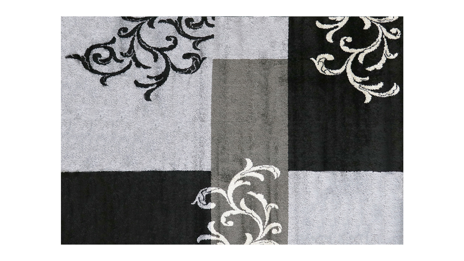 Rectangular Alyssa Rug with abstract geometric patterns in black and grey tones