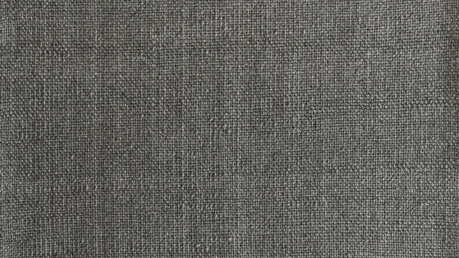 A picture of a charcoal-coloured handwoven rug.