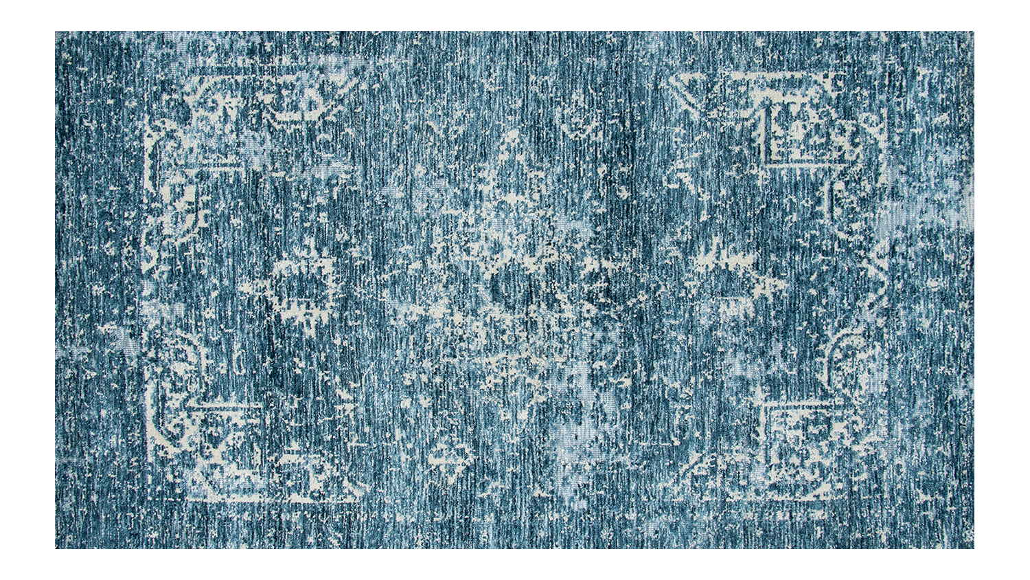 An overhead shot of a blue-toned rug with a distressed finish.