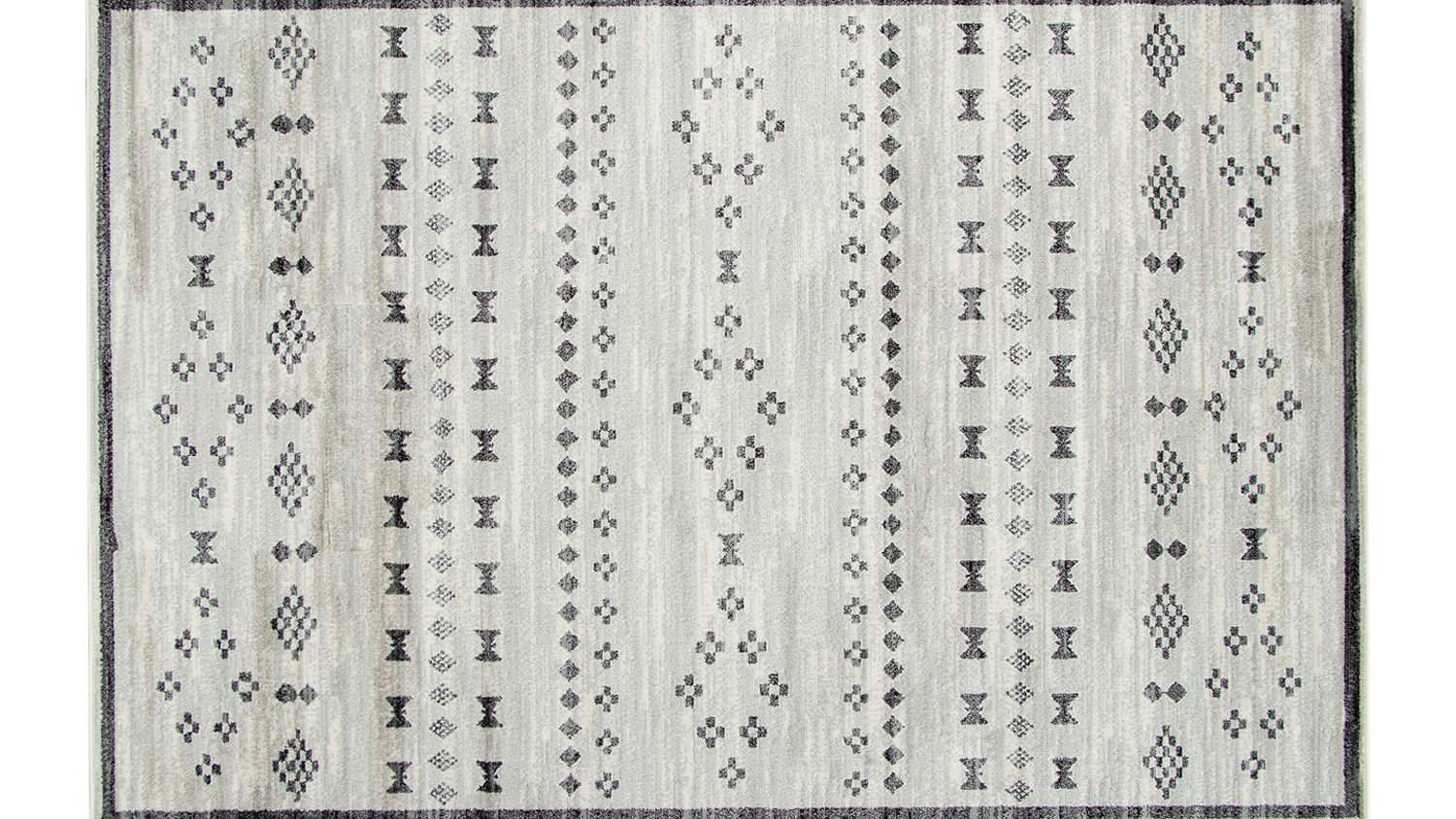 A flat-lay view of a grey-toned rug with a geometric pattern.
