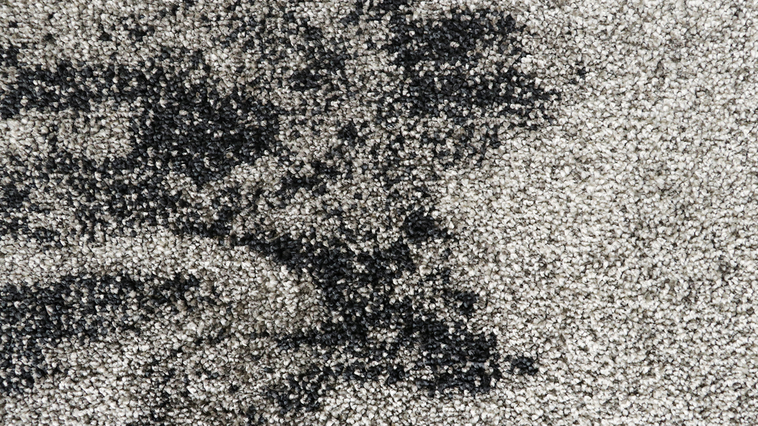 A rectangular rug featuring a grey-toned pattern with subtle distressed textures.