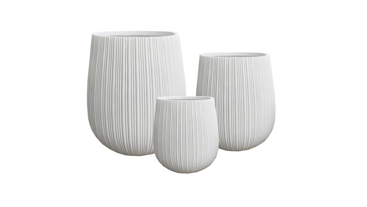 A set of three white, rounded fibreclay planters in varying sizes.
