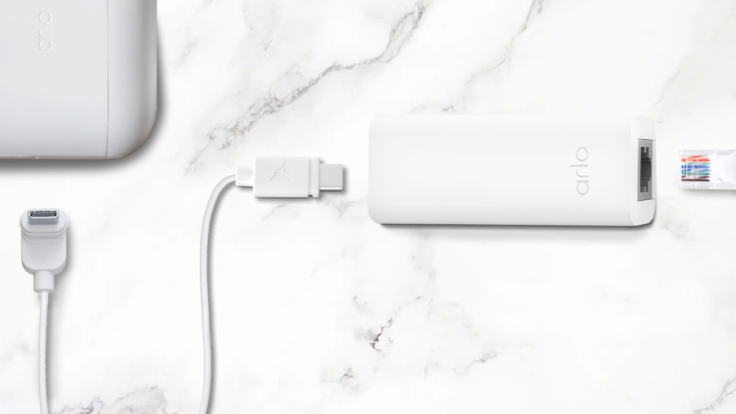 A white Arlo PoE Adapter with a zoomed-up view of an Arlo device, a USB-C cable, and an Ethernet connector.
