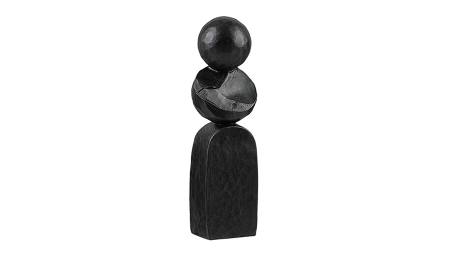 A detailed view of a small, black, decorative sculpture with abstract shapes stacked on top of a pillar