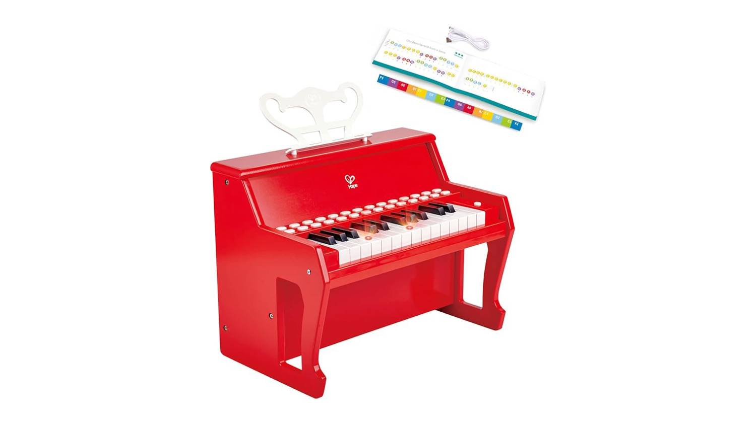 A red toy piano with a colourful instruction sheet with musical notes and a white cable.