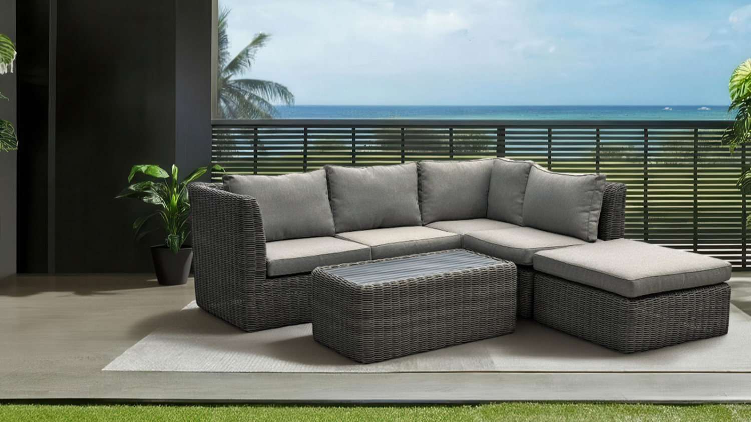 A front view of a woven outdoor lounge suite with a chaise and a separate coffee tab.