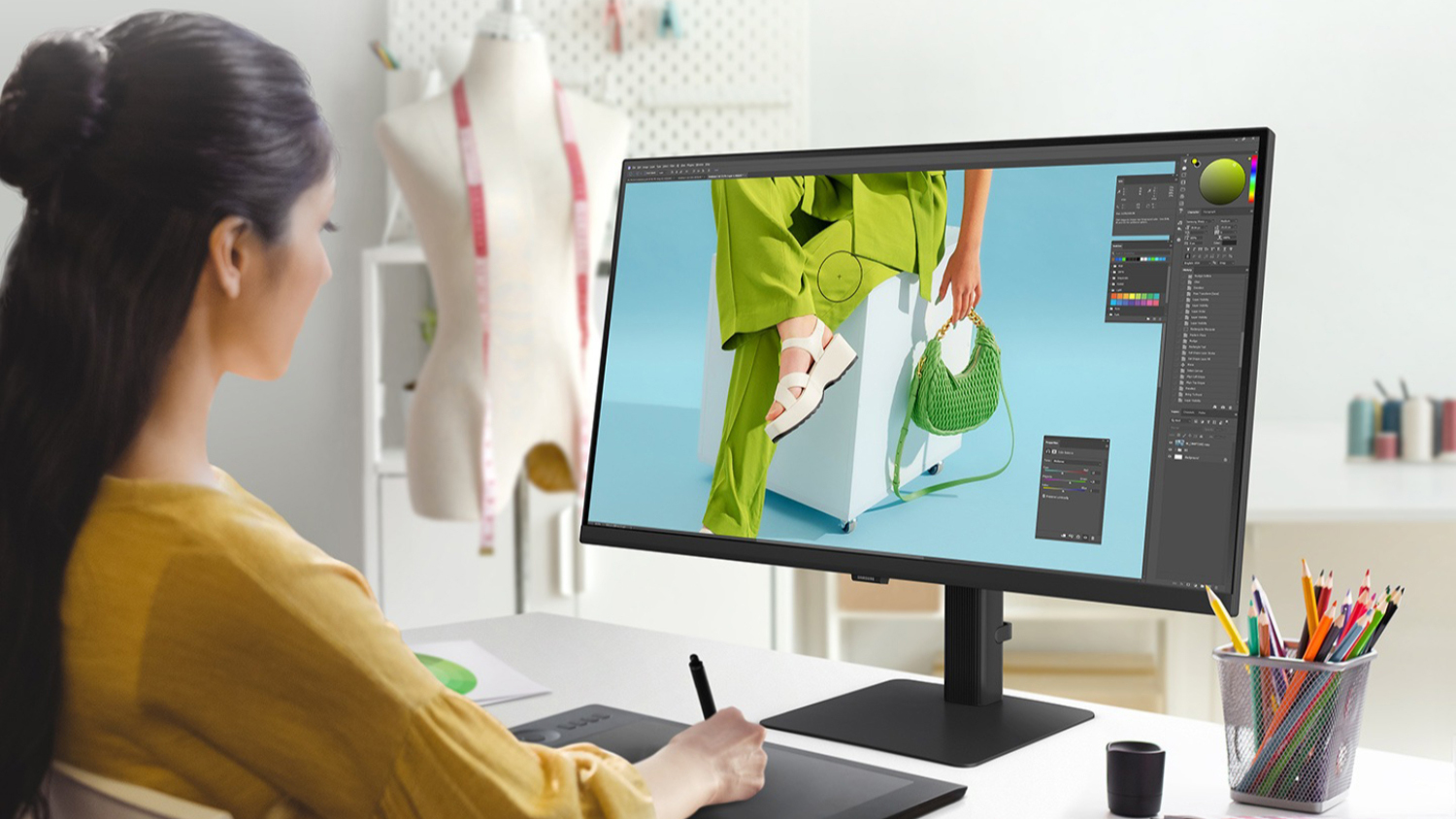 A creative professional using a Samsung monitor for design work.