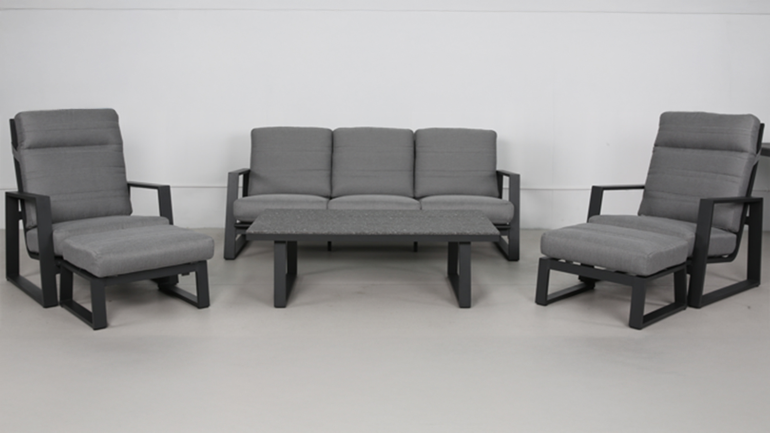 A view of the Regatta Outdoor Lounge Suite with a three-seater sofa, two armchairs with footstools, and a coffee table.