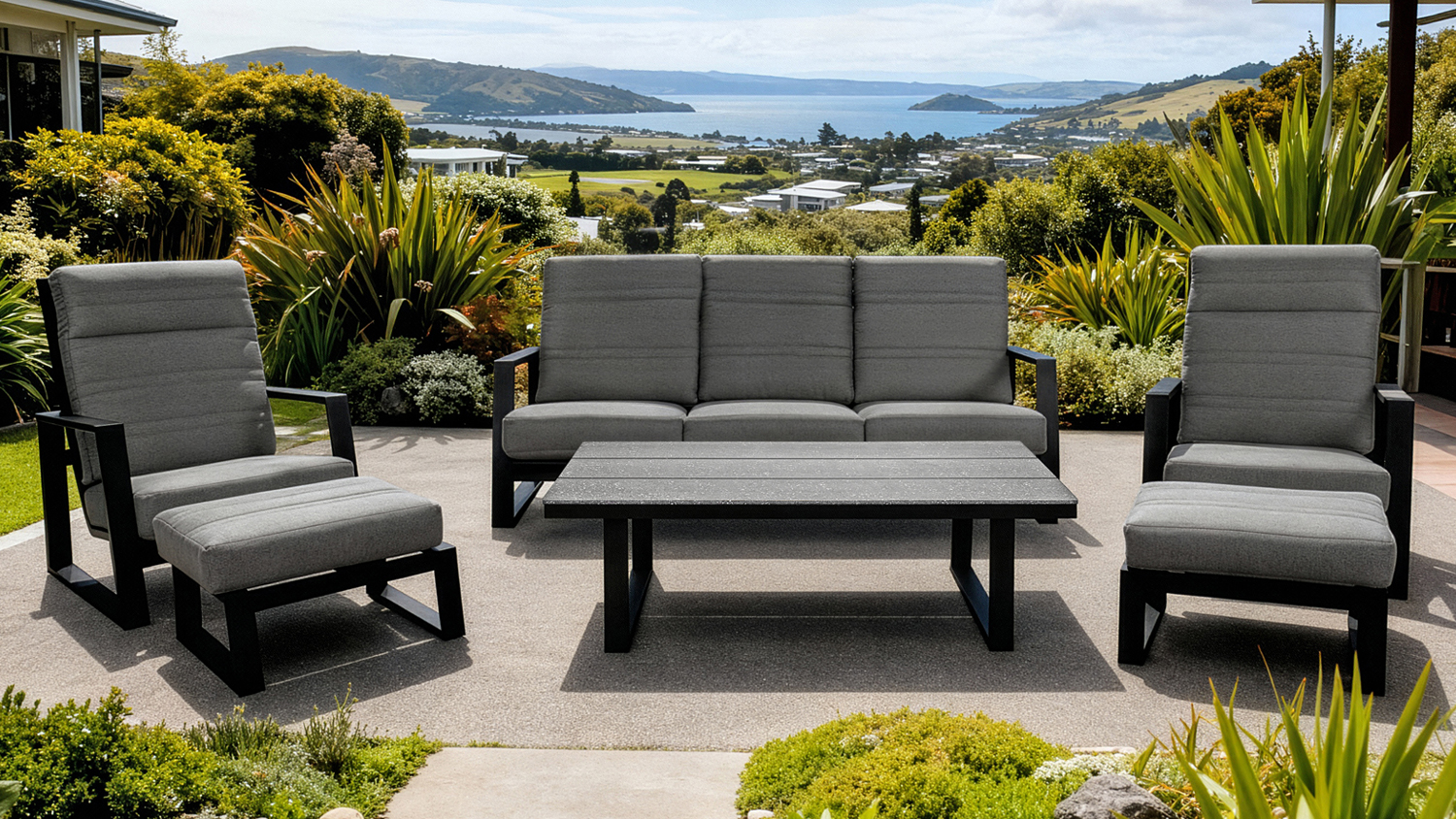 A view of the Regatta Outdoor Lounge Suite with a three-seater sofa, two armchairs with footstools, and a coffee table.