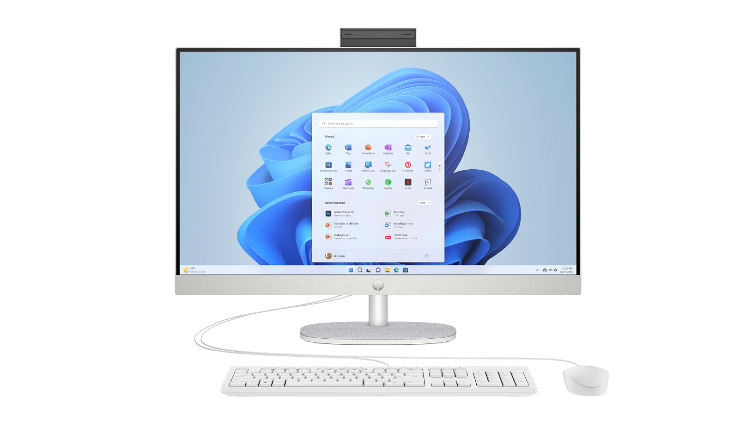 A front view of a white HP desktop computer with a raised webcam, paired with a wired keyboard and mouse.