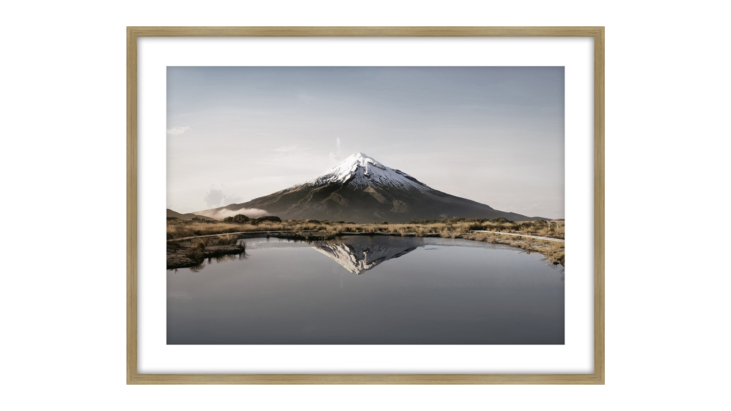 A front view of a framed print that showcases a mountain and a lake