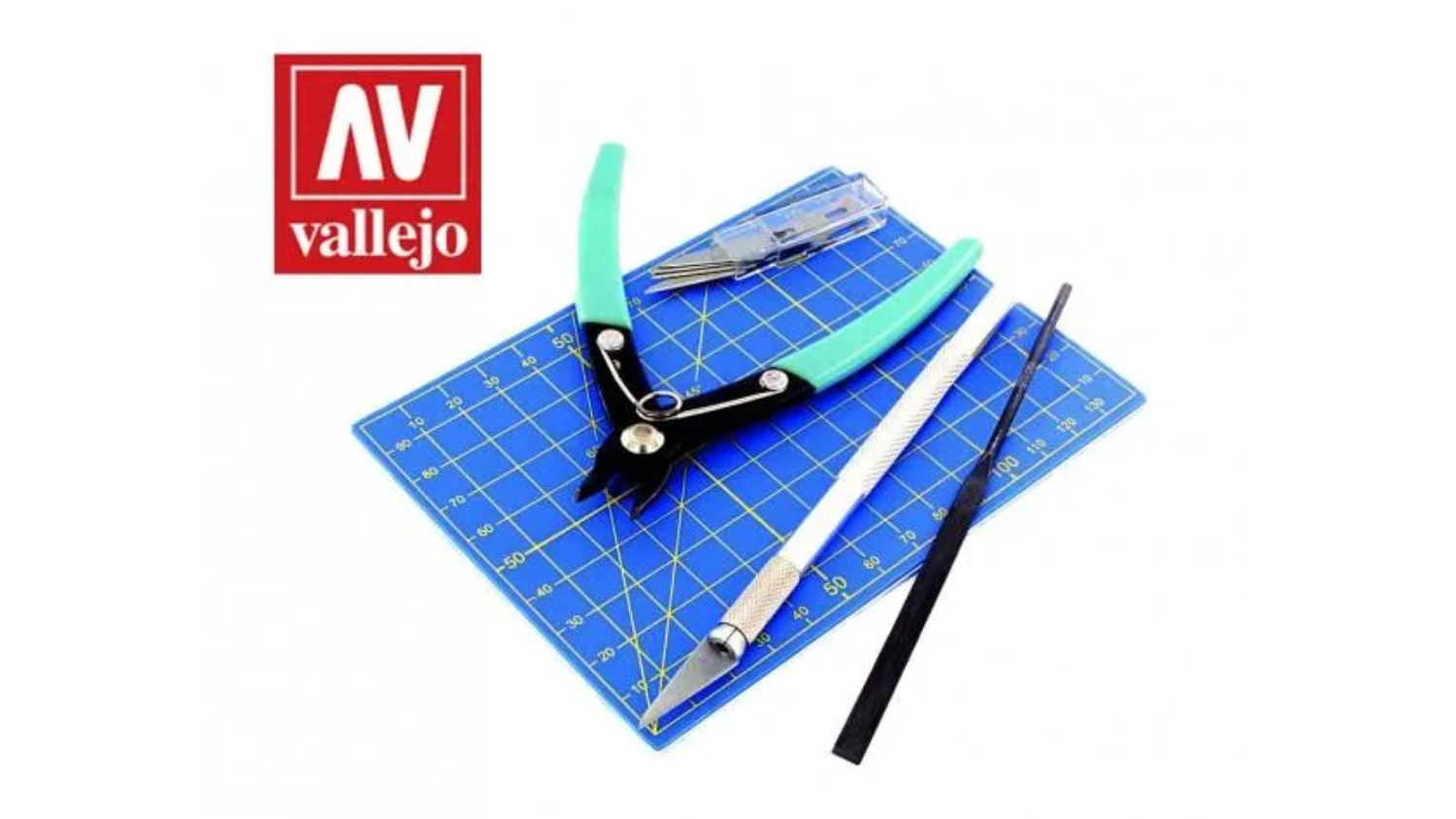 A set of modelling tools arranged on a blue cutting mat.