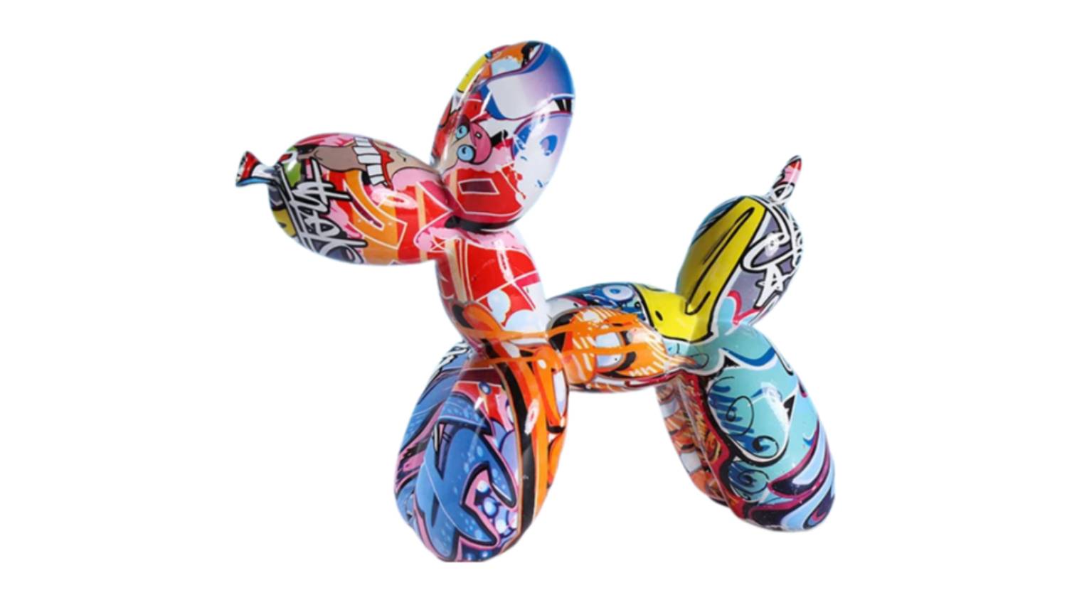A balloon dog sculpture with vibrant graffiti-style designs in red, blue, yellow, and orange patterns