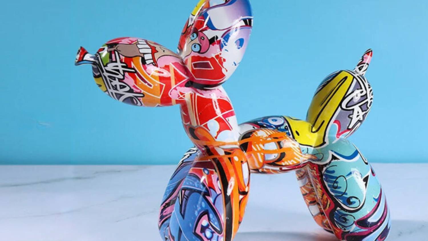 A balloon dog sculpture in a blue room setup