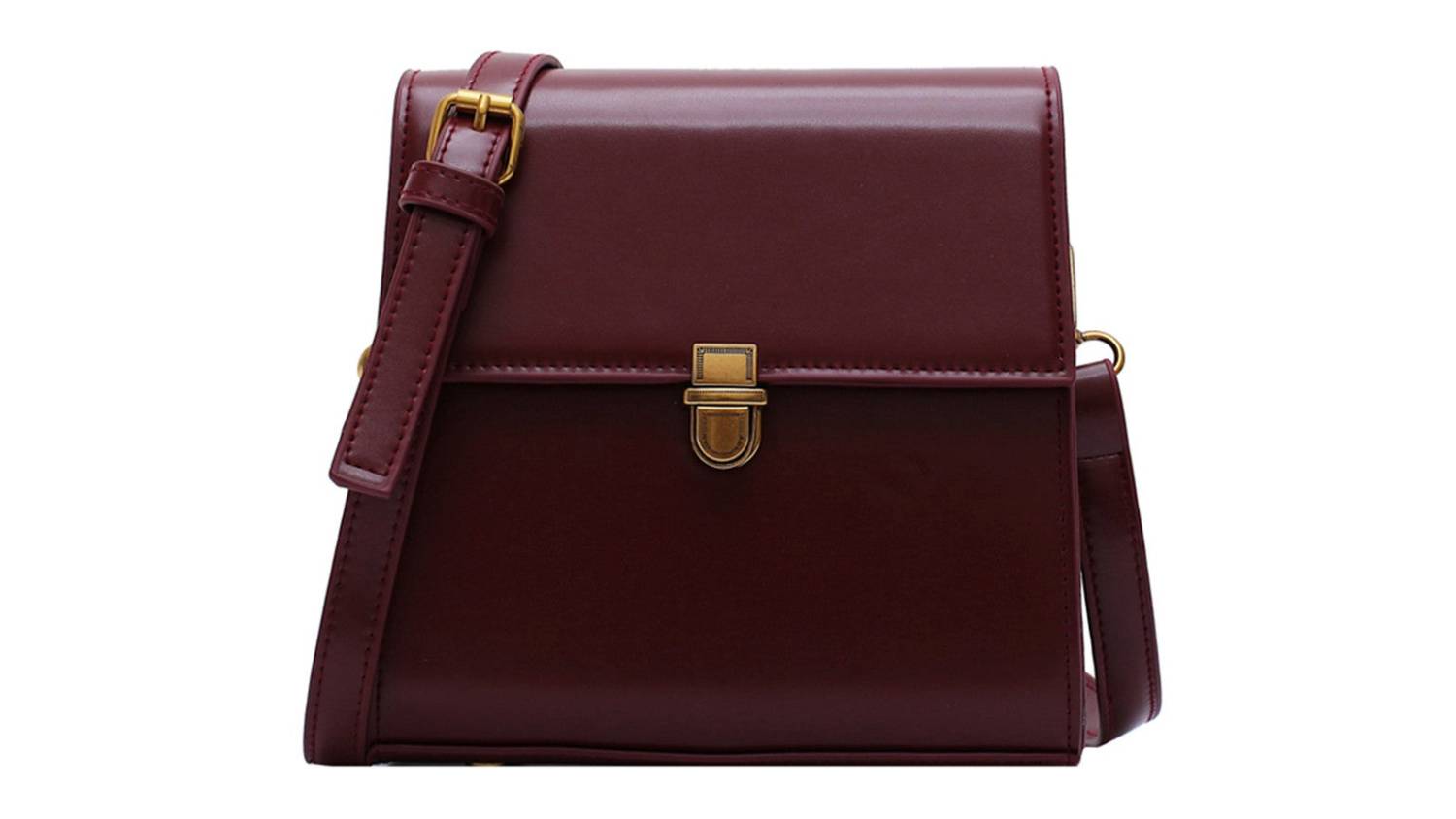 A maroon leather crossbody bag with a gold buckle and an adjustable strap