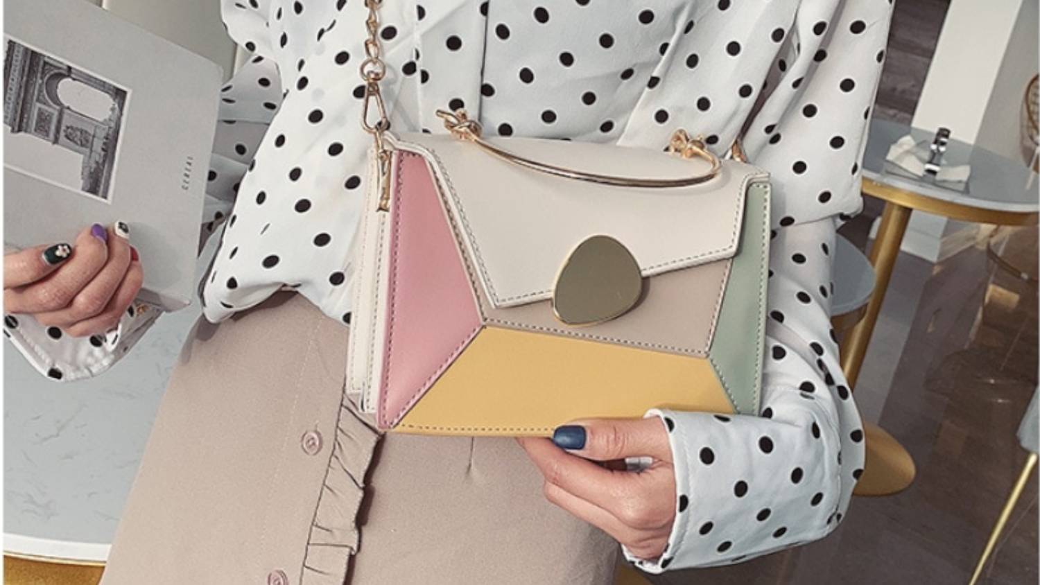 A close-up of a person holding the contrast bag