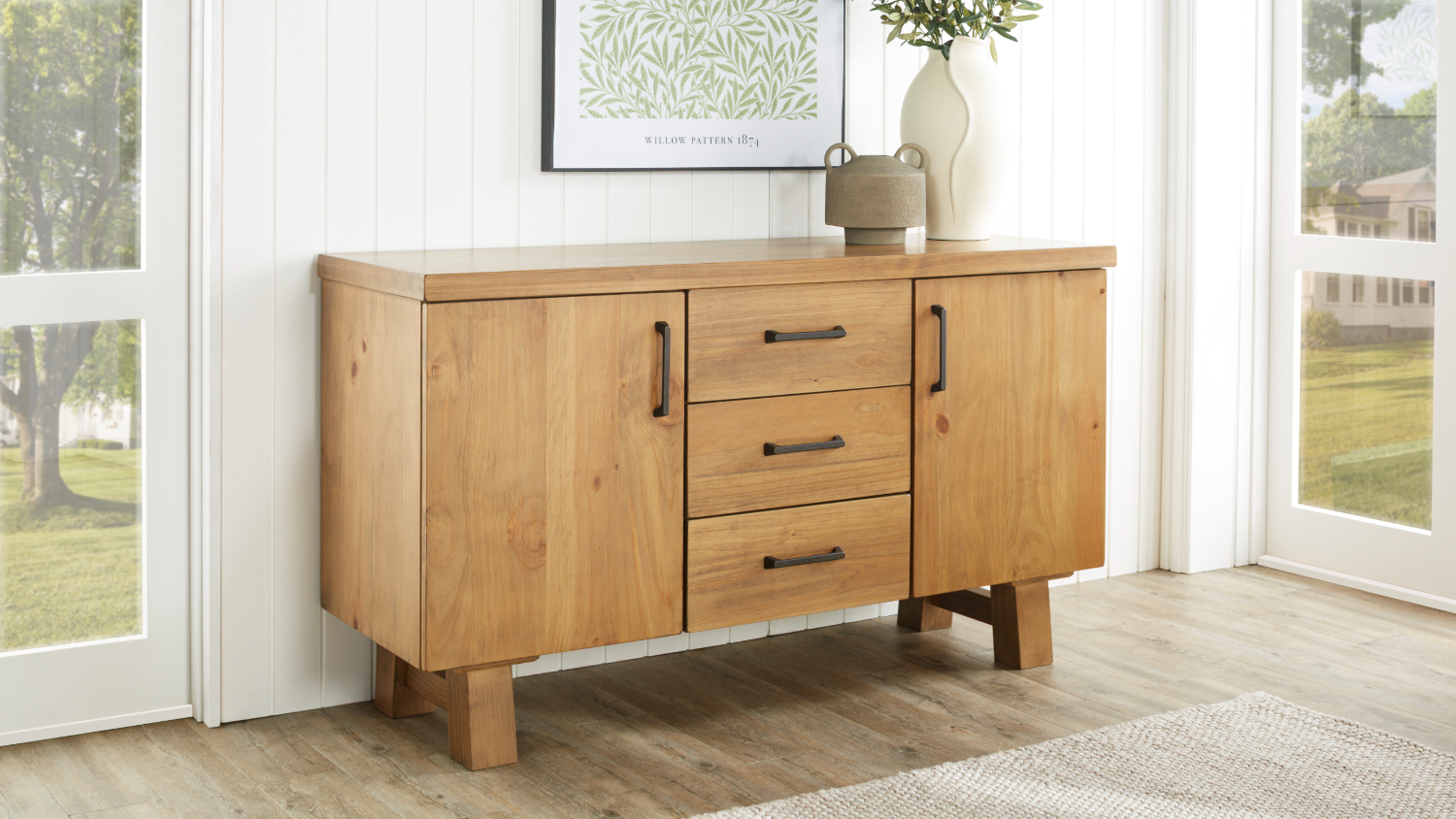 A view of a buffet table in a light and inviting dining room setup