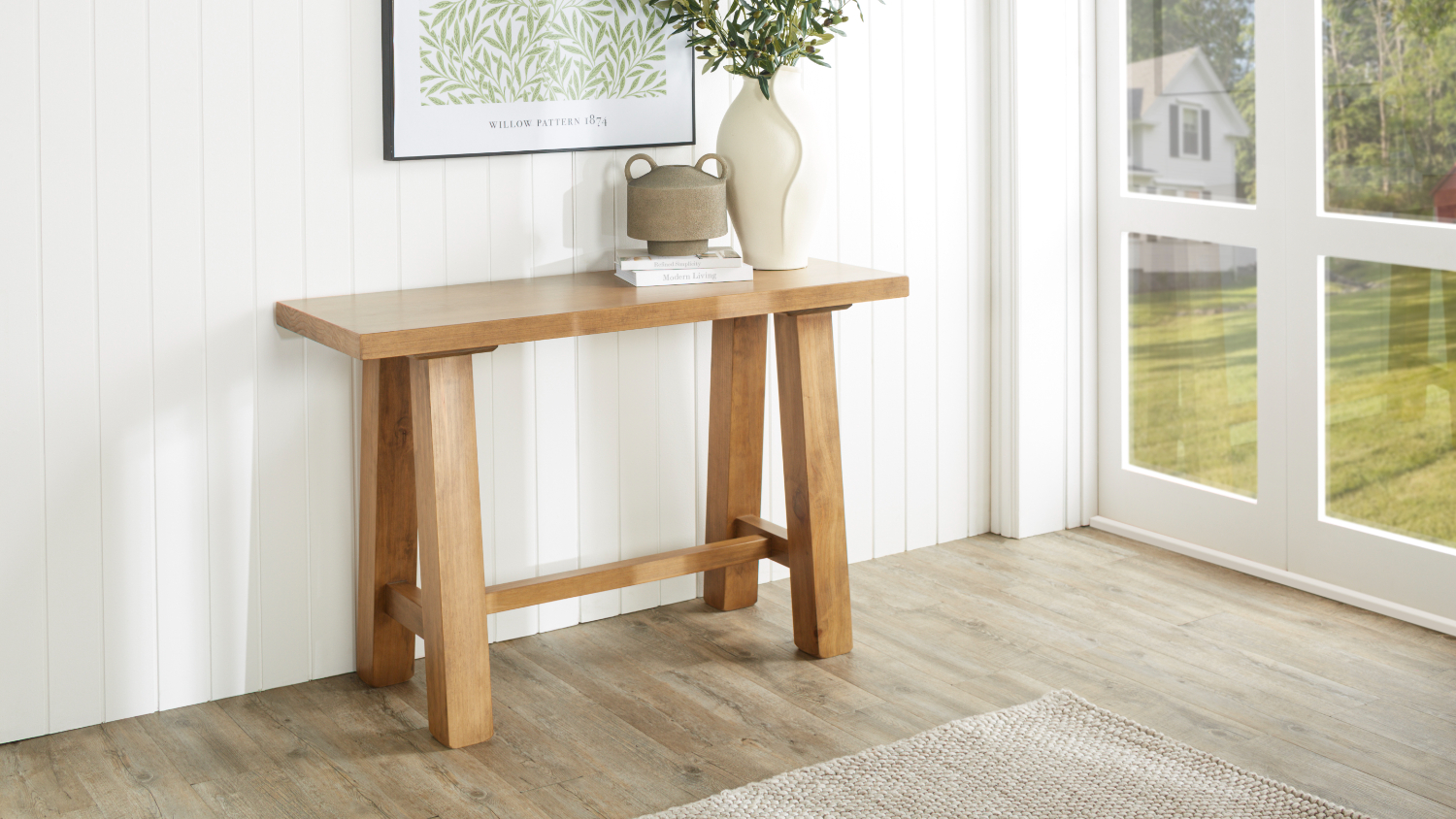 A wide view of the hall table, beautifully displayed in a light and inviting entryway