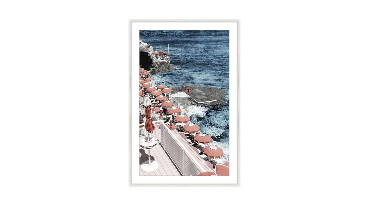 A framed picture showcases a beach scene, featuring gentle waves and sandy shores.