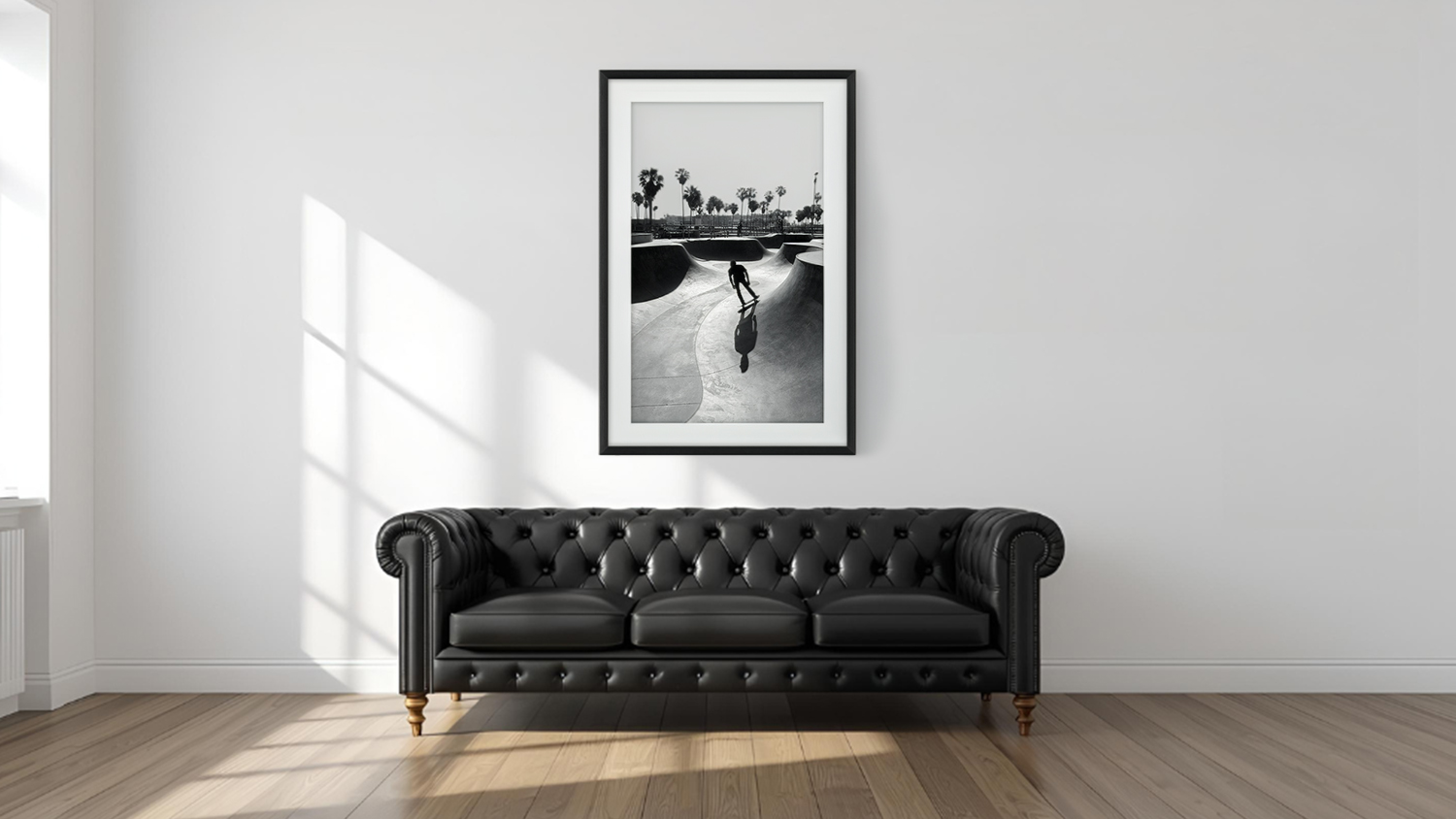 Framed photo hangs above sofa in a modern living room with light wood flooring.