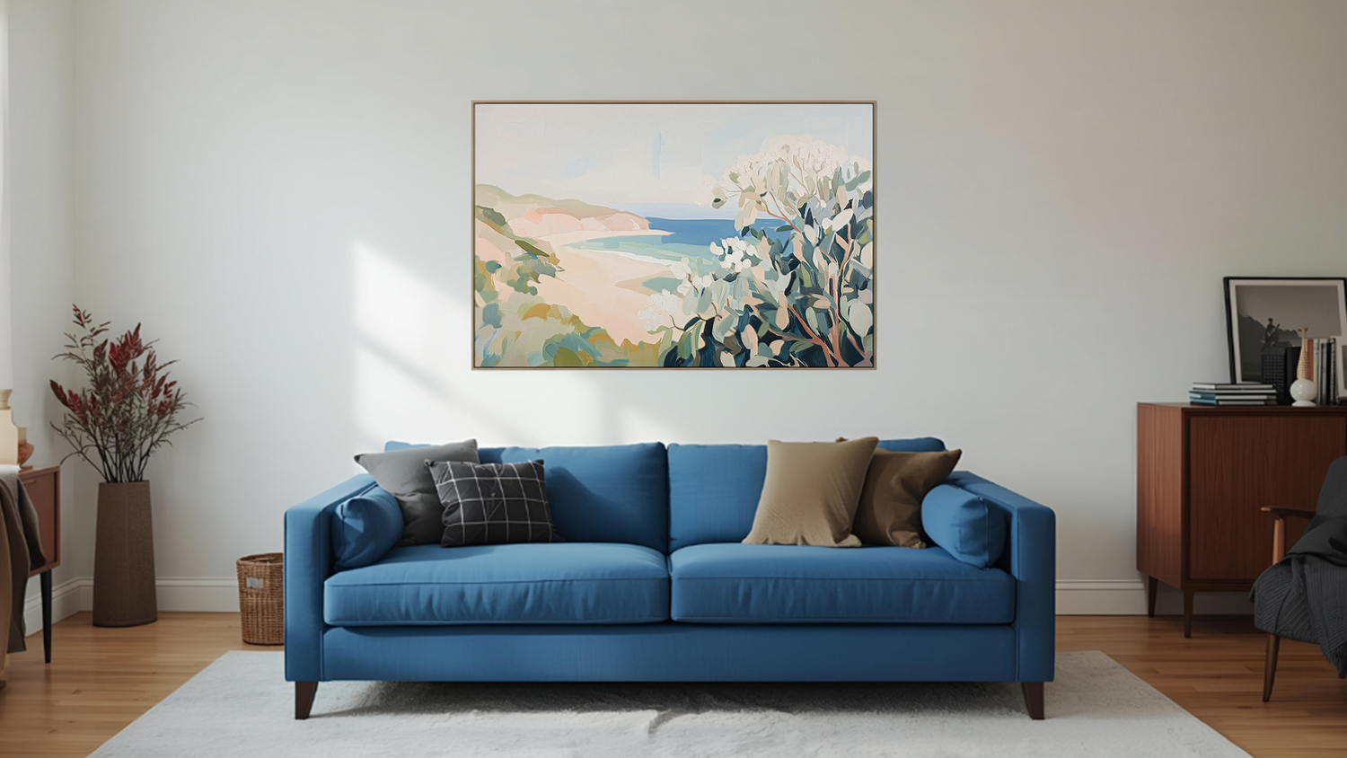 Framed photo hangs above sofa in a modern living room with wooden flooring.