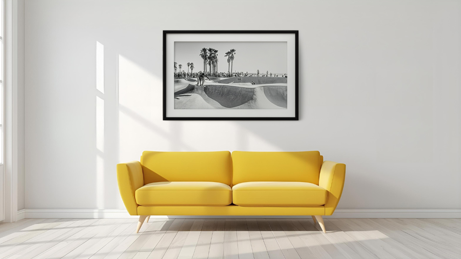 Framed photo hangs above sofa in a modern living room with wooden flooring.