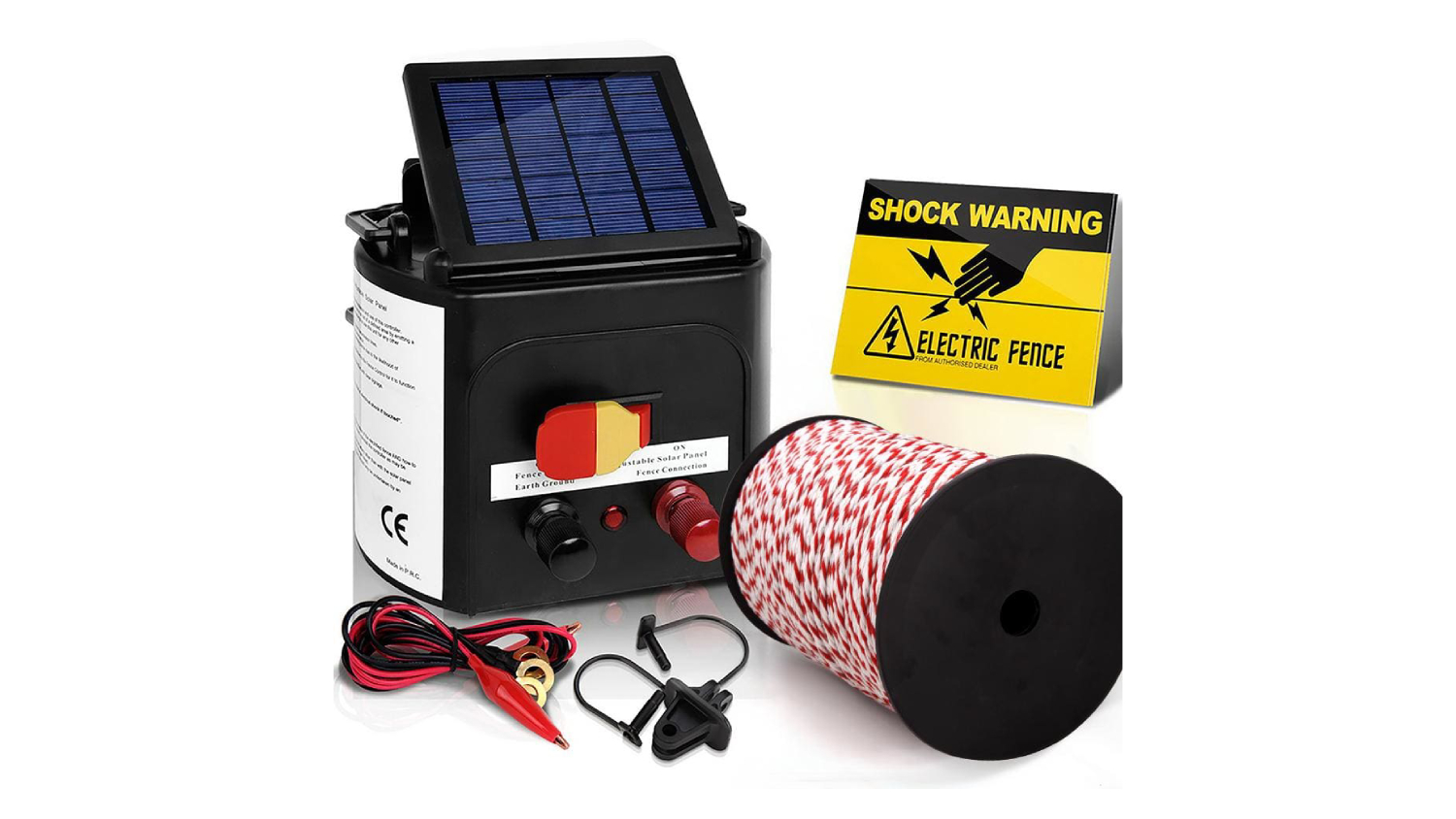 Solar-powered fence charger with red-white wire spool, warning sign, and connection cables