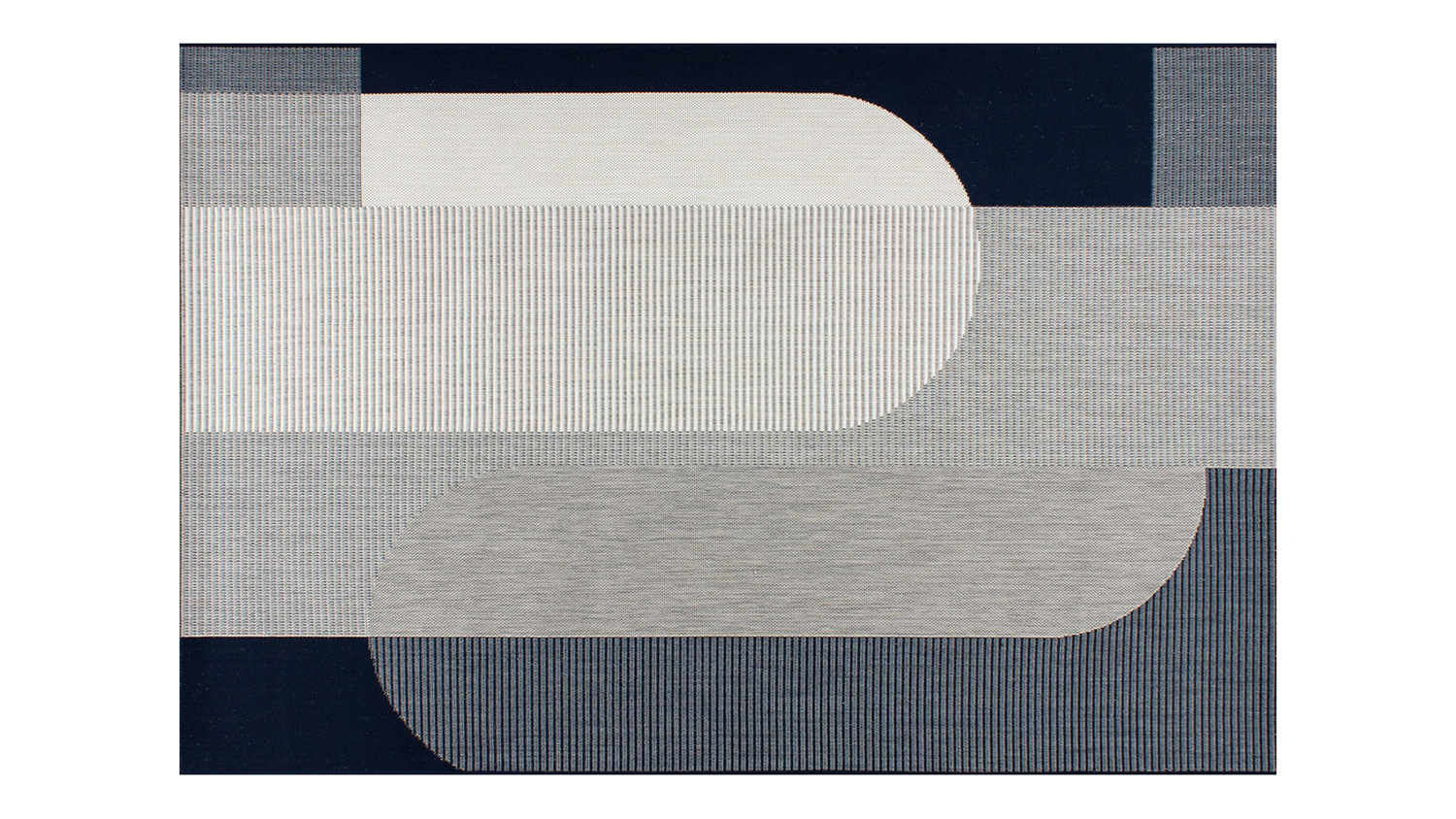 Geometric patterned rug in shades of navy blue and grey.
