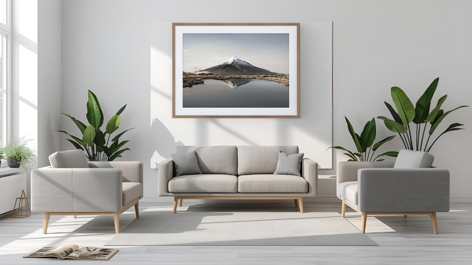Artwork piece hangs above sofa in a modern living room with plants and wood flooring.