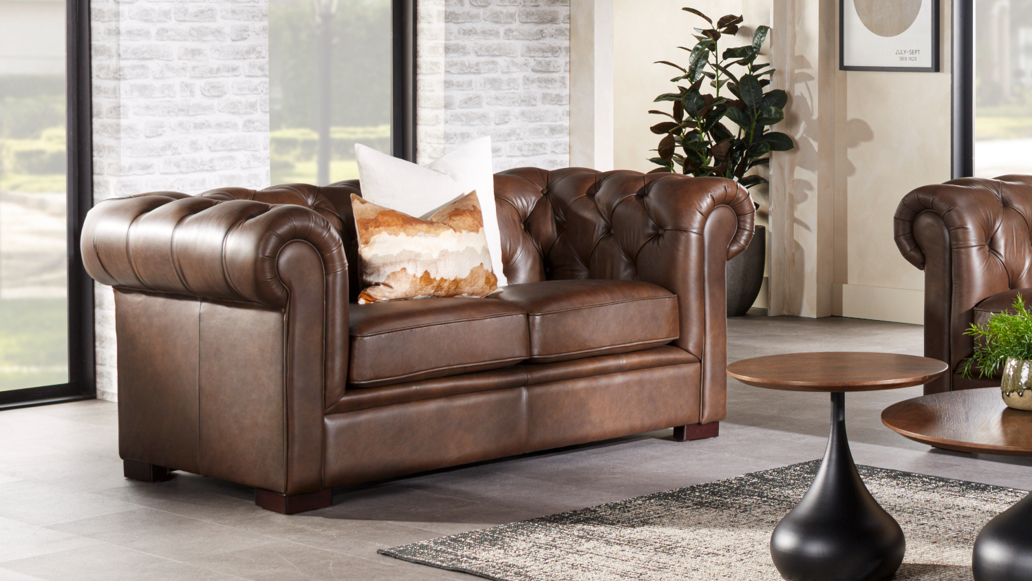 Front view of a classic brown leather Chesterfield 2-seater sofa
