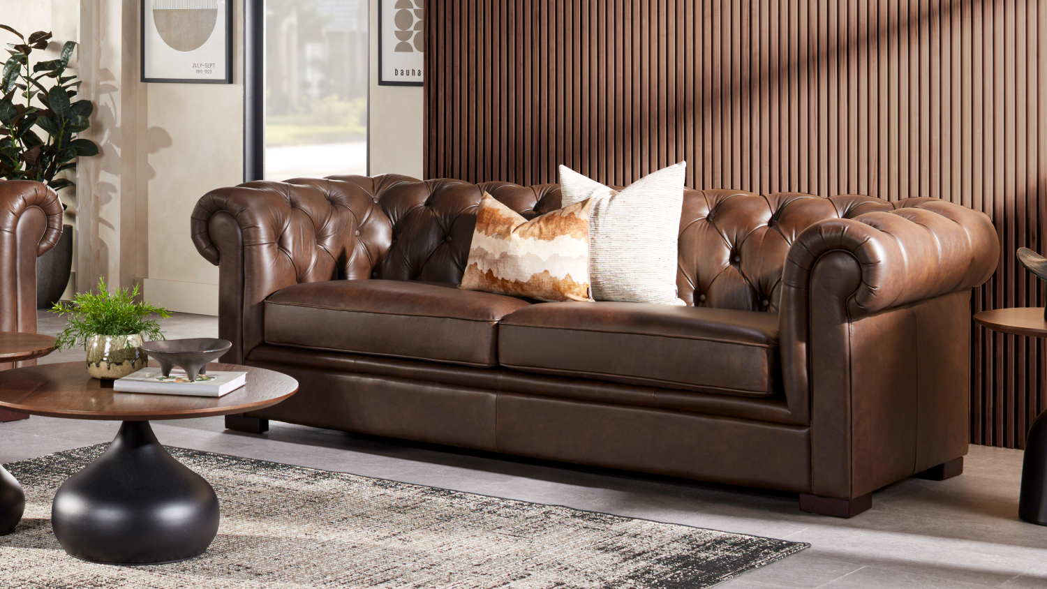 Front view of a classic brown leather Chesterfield 3-seater sofa
