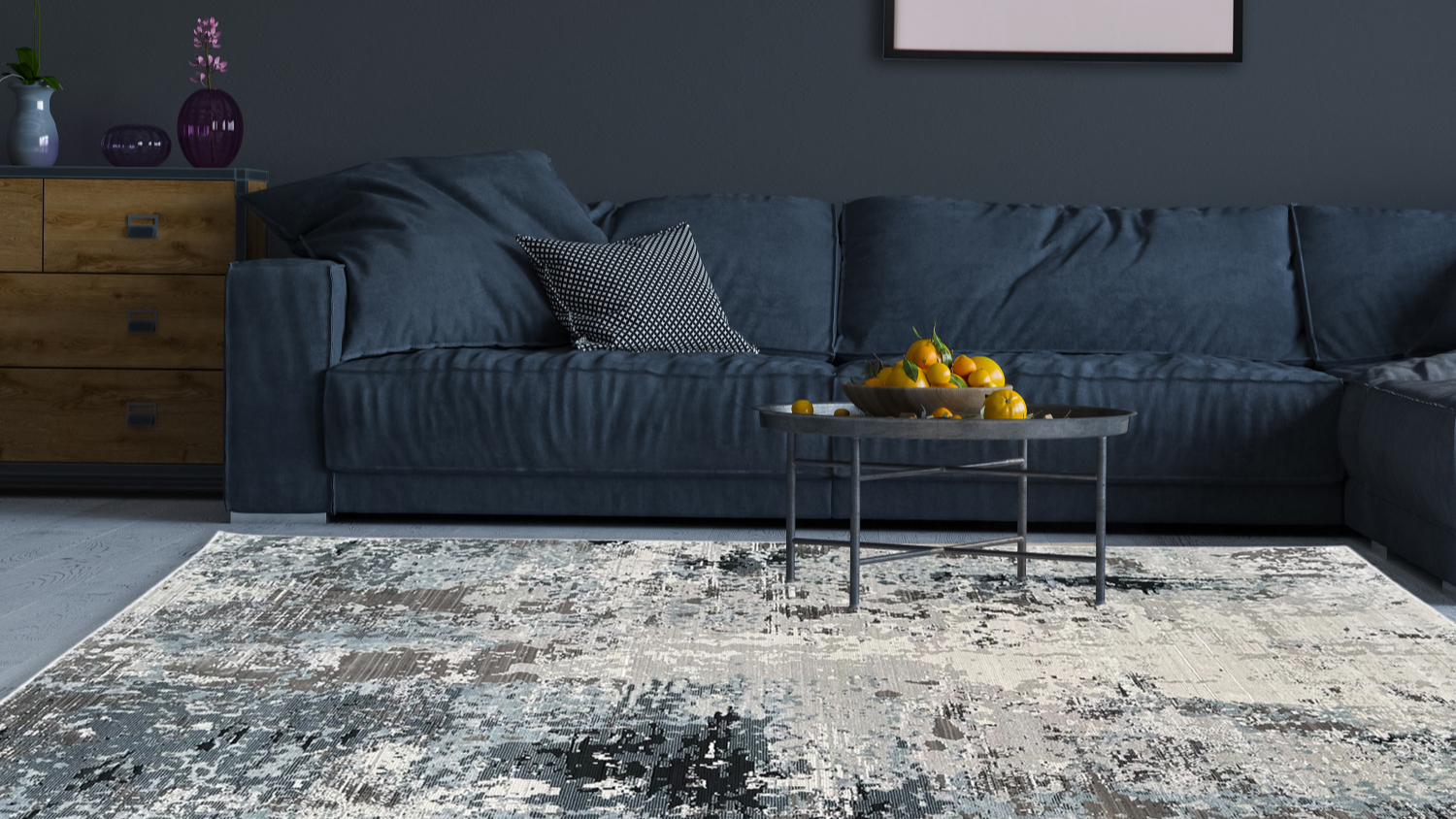Living room with blue sofa and abstract grey-blue rug.