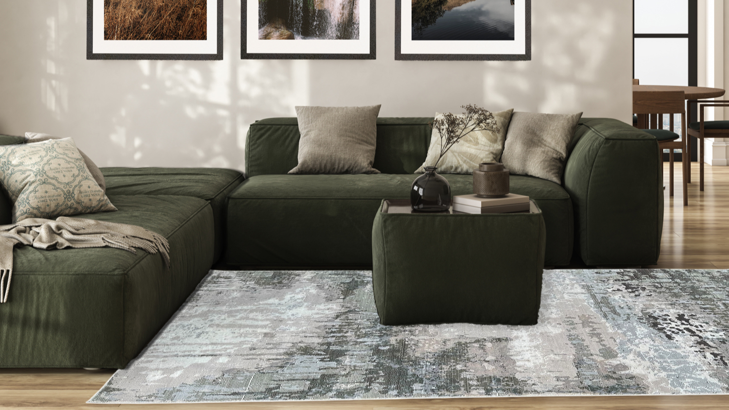 Living room with dark green sectional sofa and abstract area rug in grey and green tones.