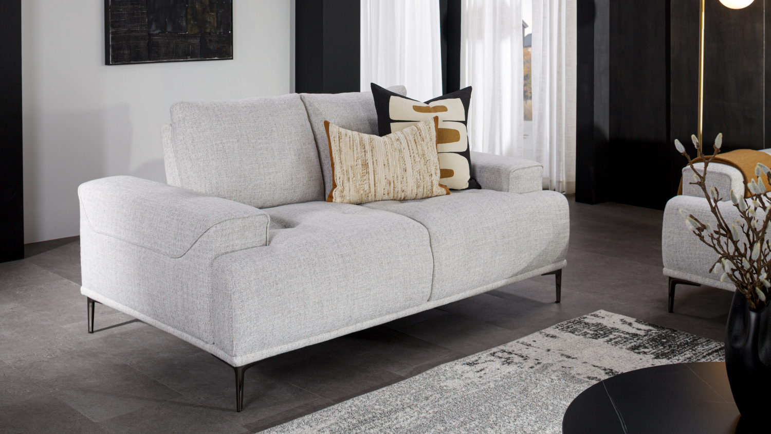 A front view of the two seater fabric sofa in a modern living room