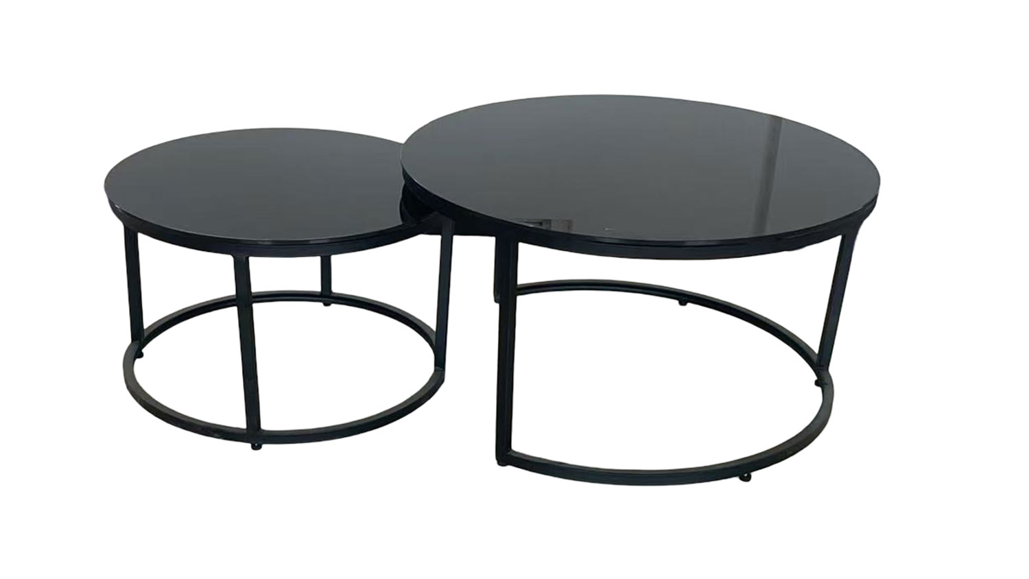 Cielo Nest of 2 Tables. Two stylish round black glass nesting tables with metal frames, one slightly smaller and tucked under.
