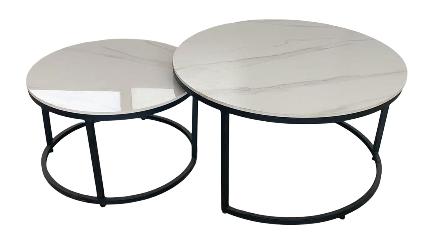 Comet Nest of 2 Tables. Two sleek, contemporary round white sintered stone nesting tables with black metal frames, one slightly smaller and tucked under.
