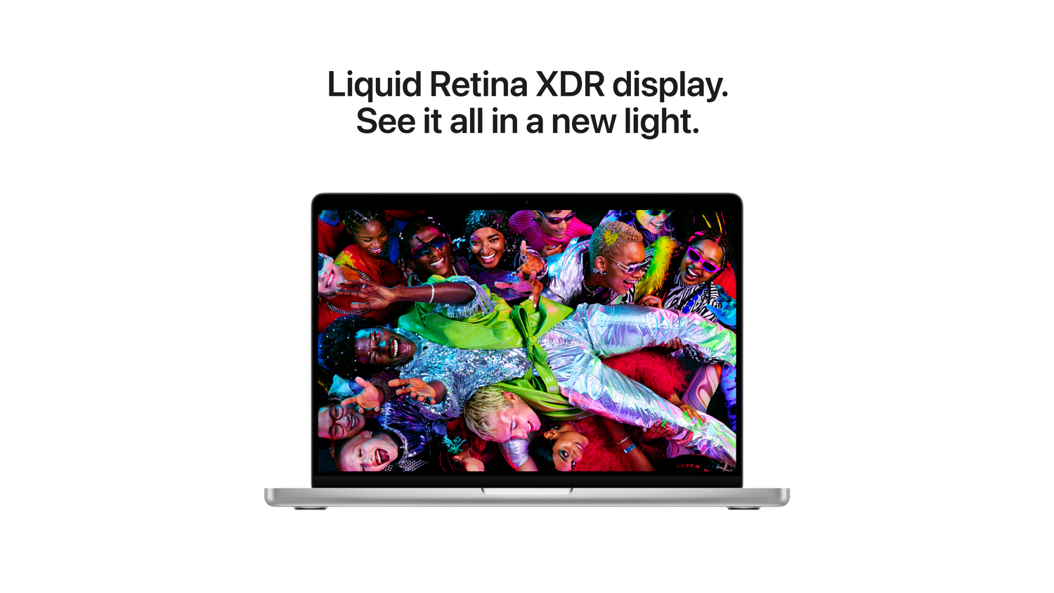 A silver Apple MacBook Pro displaying a vivid, colourful photo with text: "Liquid Retina XDR display. See it all in a new light."