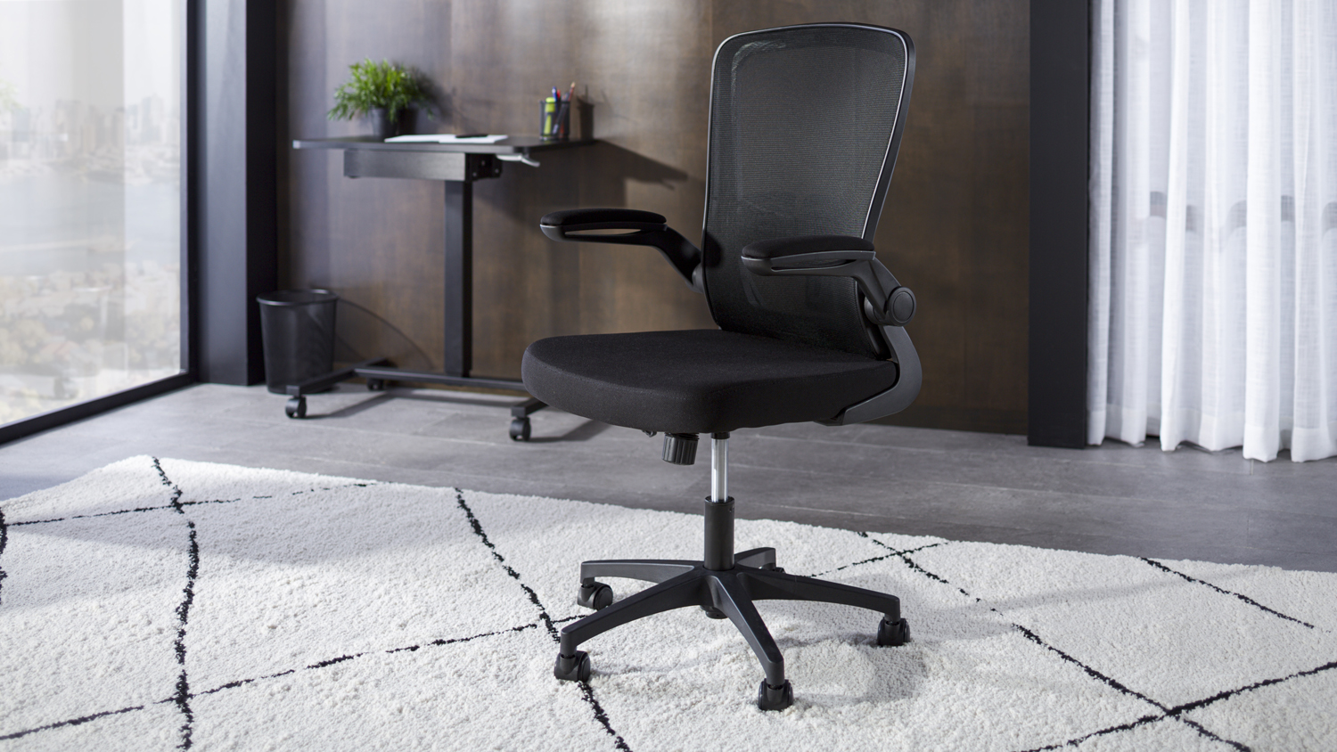 Black Anchor Office Chair with a breathable mesh backrest, cushioned seat, and flip-up armrests