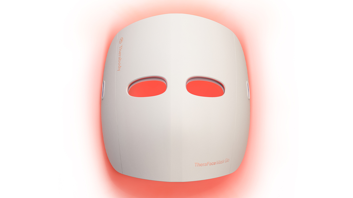 Front view of a white LED facial mask glowing red around the edges, with the Therabody logo visible