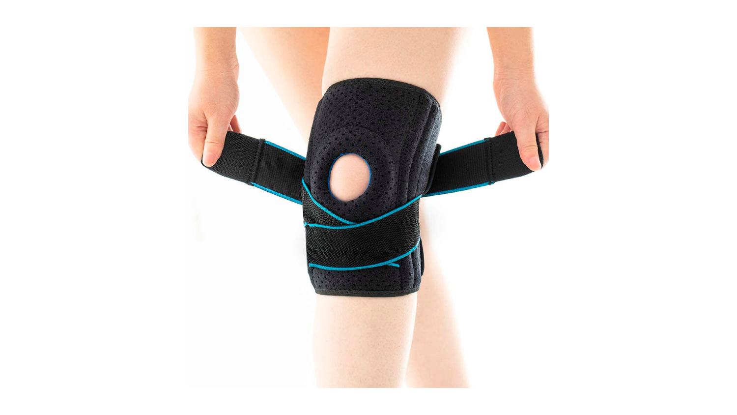 A person’s hand fastening an adjustable knee brace with an open patella design 